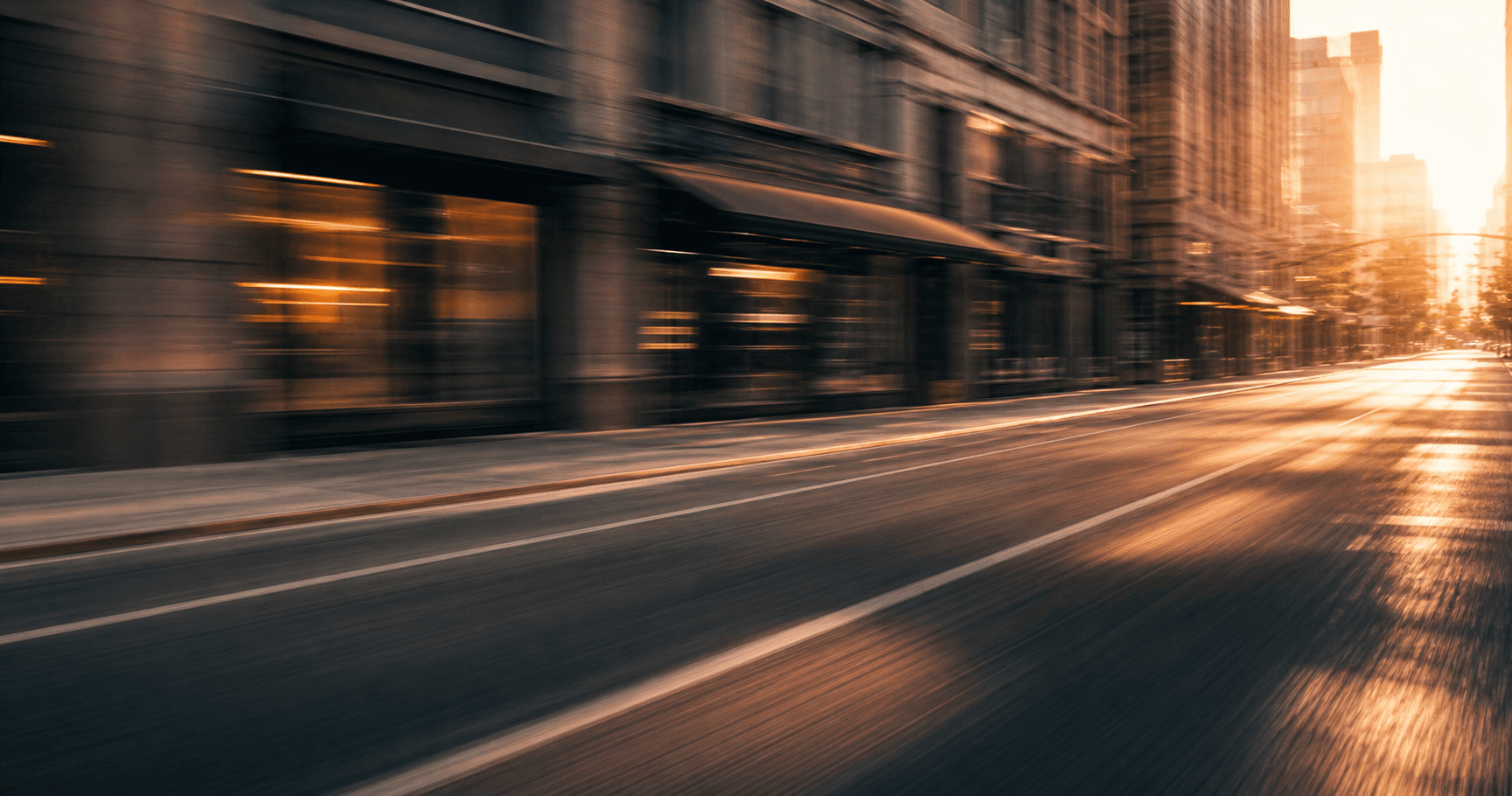 Motion-blurred city street at golden hour